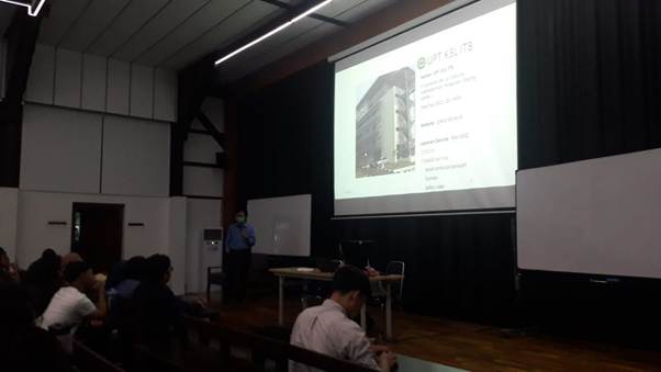 A person sitting in front of a projector screen
AI-generated content may be incorrect.